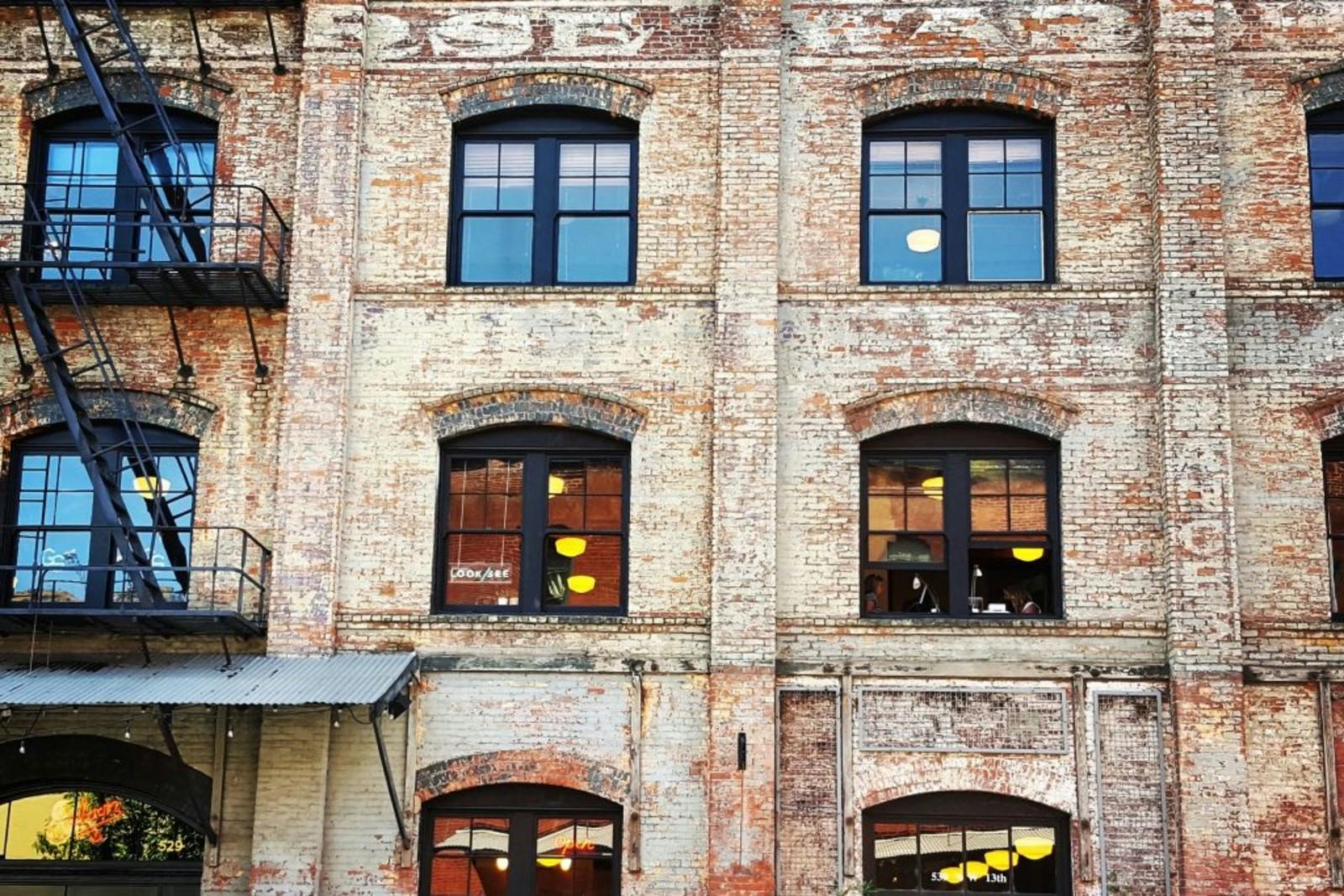 Outside exterior view of a vintage brick building that has been converted from a warehouse to office space